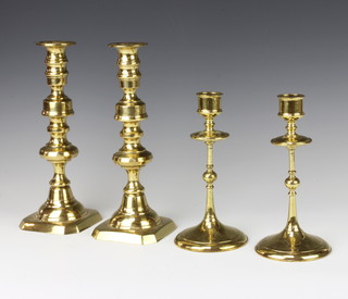 A pair of 19th Century brass candlesticks with ejectors 25cm and a pair of brass candlesticks 20cm  