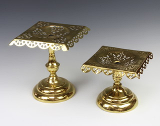 A Victorian square embossed and pierced brass pedestal stand marked Prov.Pat 1083 17cm x 19cm x 20cm and 1 other 24cm x 22cm x 23cm 
