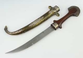 A Jambuka style dagger with 22cm blade contained in a gilt metal and "silver" scabbard with wooden grip 