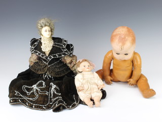 A wax doll in period costume, a porcelain headed doll and 1 other doll with celluloid head 