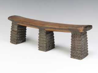 A Zulu wooden head rest (isiGqiki) on three amasumpa carved supports 13cm x 42cm x 8cm 
