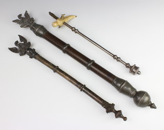A 19th Century Friendly Society sceptre with phoenix finial, the base marked Ogotasp Hon JG Adderley Lodge 52cm together with a similar sceptre the base unmarked 66cm and a steel and ivory sceptre surmounted by a standing figure of a lady and child 44cm 