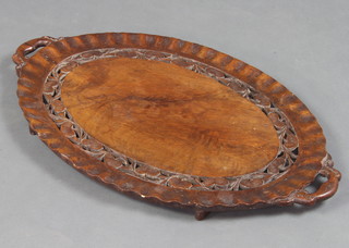 A Japanese pierced and carved hardwood twin handled tea tray 60cm x 38cm 