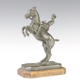 A French bronze figure of Cavalryman from the Cadre Noir raised on a wooden base 25cm x 16cm x 11cm, indistinctly signed to the base 