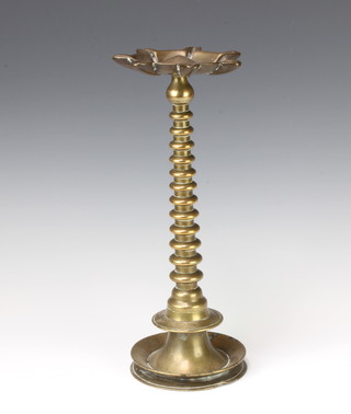 A 19th Century bronze Indian temple oil lamp on bobbin turned supports and circular base 34cm