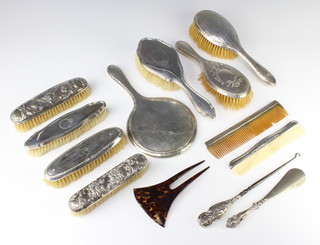 A matched silver 3 piece dressing table set Birmingham 1922/23, 5 other brushes, 2 combs, a shoe horn, a button hook and hair pin 
