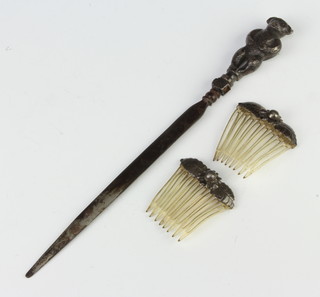 A silver handled letter opener and 2 hair combs 