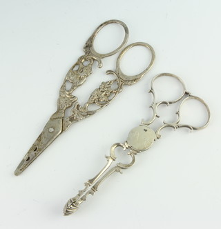 A pair of Continental silver grape scissors and a pair of Georgian silver sugar tongs 71 grams