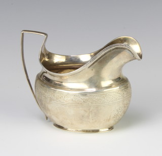 A Georgian silver cream jug with chased decoration 98 grams 
