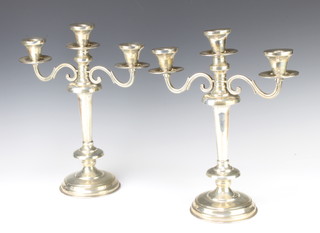 A pair of sterling silver 3 light candelabra, 2133 grams, 37 cms