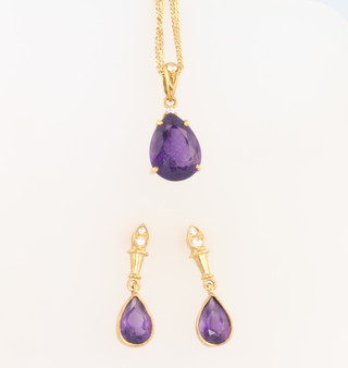 An 18ct yellow gold pear cut amethyst and diamond pendant and a pair of ensuite earrings
