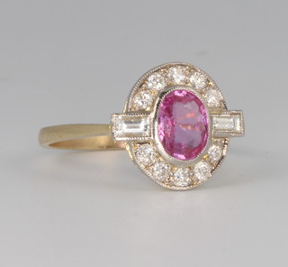 An 18ct yellow gold oval pink sapphire and diamond cluster ring, the centre stone approx. 0.5ct surrounded by baguette and brilliant cut diamonds approx. 0.35ct, size O 