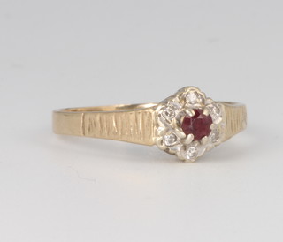 A 9ct yellow gold ruby and diamond cluster ring size M, 2 grams