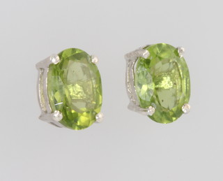 A pair of silver and peridot ear studs 
