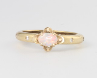 An 18ct yellow gold opal ring, the shank set with diamonds, size N, 3.1 grams