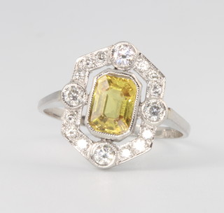 A platinum yellow sapphire and baguette cut diamond ring, the centre stone approx. 1.5ct, the diamonds approx. 0.35ct, size O 1/2