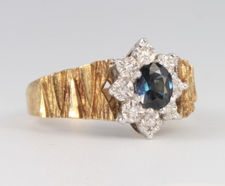 An 18ct yellow gold sapphire and diamond ring, the oval cut centre stone approx. 0.5ct, size L 1/2, 6.6 grams