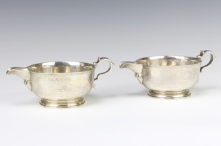 A pair of stylish silver sauce boats with S scroll handles, London 1928, maker Shapland 526 grams 