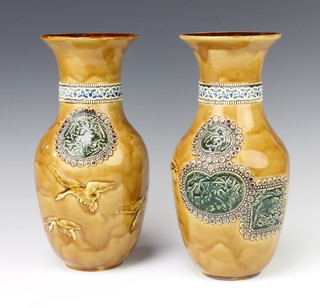 A pair of Doulton Lambeth oviform vases decorated in the Japanese style with flying birds and stylised flowers 29cm 