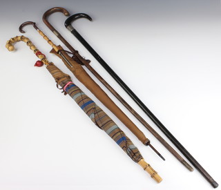 A silver mounted walking cane, 1 other and 2 parasols 