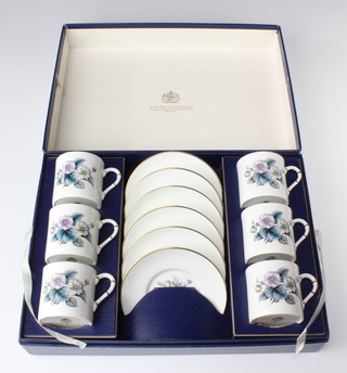 A boxed set of Royal Worcester coffee cans and saucers decorated flowers 