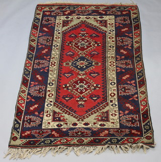 A tan, red and blue ground Afghan rug with a multi row border 200cm x 127cm 