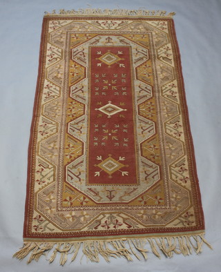 A Caucasian style brown and green ground rug with central medallion 230cm x 130cm 