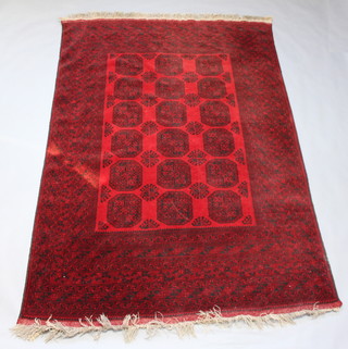 A red and black ground Afghan carpet with 18 octagons to the centre within a multi row border 290cm x 198cm 