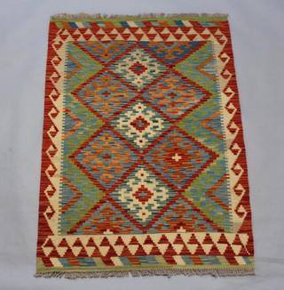 A Kilim green, sand and tan ground rug with all over geometric design 125cm x 88cm 

