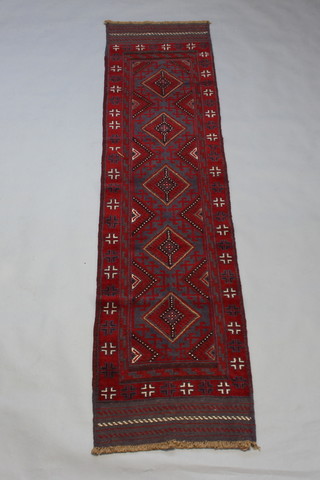 A Meshwani red and blue ground runner with 5 diamonds to the centre within a multi row border 260cm x 63cm 