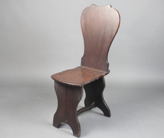 A Georgian mahogany hall chair with solid seat and back, raised on panel supports