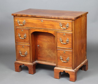 A Georgian style mahogany desk/dressing table fitted a drawer, the centre fitted a cupboard flanked by 4 short drawers, raised on cabriole supports 72cm h x 81cm w x 41cm d 