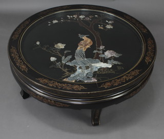 A circular Chinese black lacquered and inlaid hardstone occasional table decorated a tree with mythical bird and Grecian key decoration to the apron, raised on shaped supports 38cm x 110cm diam. 