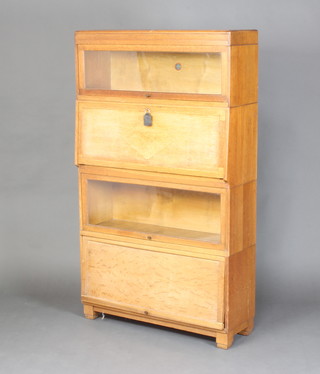 A light oak 4 section Globe Wernicke bureau bookcase, the top section fitted a glazed panel, the 2nd section with fall front revealing a fitted interior with pigeon holes, the 3rd section fitted a bookcase enclosed by a glazed panel, the base enclosed by a panelled door 147cm h x 85cm w x 28cm d 