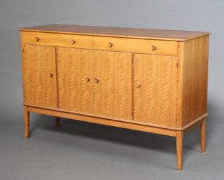 Gordon Russell, a teak sideboard fitted 2 long drawers above cupboards enclosed by 4 panelled doors with tore handles, raised on turned supports, the back labelled Gordon Russell Ltd, Broadway Worcs.  87cm h x 140cm w x 46cm w 