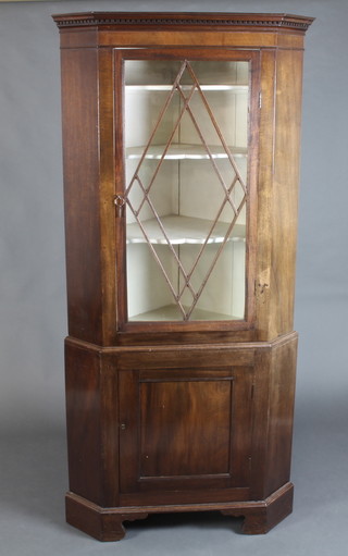 A Georgian mahogany double corner cabinet, the upper section with moulded and dentil cornice, fitted shelves enclosed by astragal glazed panelled doors, the base enclosed by a panelled door, raised on bracket feet 190cm h x 90cm w x 58cm d  
 