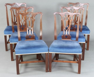 A set of 6 Chippendale style mahogany dining chairs with pierced vase shaped slat backs and over stuffed seats, raised on square supports with H framed stretcher 