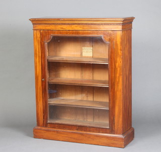 A Victorian walnut pier cabinet with Grecian key decoration fitted shelves enclosed by a glazed panelled door, raised on a platform base  (interior labelled from Solomons Office and Household Furniture Warehouse Queen Victoria Street) 151cm h x 82cm w x 30cm d