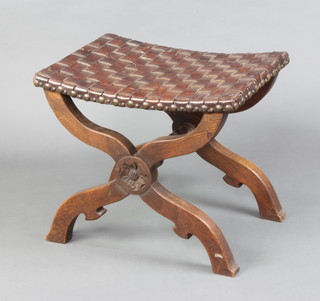 An Italian style X framed stool with woven leather seat, carved a rose and with turned stretcher 46cm h x 53cm w x 40cm d 
