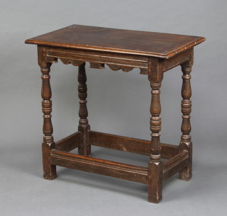 An 18th Century oak occasional table raised on turned and block supports with box framed stretcher 77cm h x 81cm w x 45cm d 