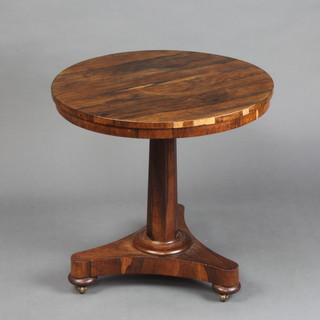 A William IV circular rosewood occasional table raised on a chamfered column, triform base and bun feet 54cm h x 54cm diam. 