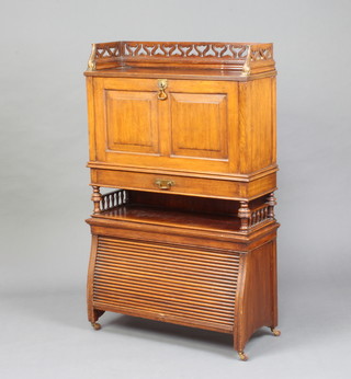 A Continental Art Nouveau mahogany bureau with pierced 3/4 gallery, the fall front revealing a fitted interior with pigeon holes, above 1 drawer, base fitted a tambour shutter enclosed by panelled doors 112cm h x 70cm w x 26cm d 