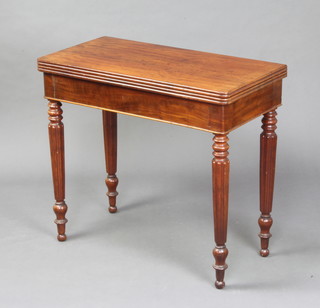 A Victorian mahogany D shaped card table, raised on turned and reeded supports 75cm h x 83cm w x 41cm d 