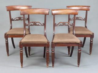A set of 4 19th Century mahogany bar back dining chairs with carved and pierced mid rails upholstered drop in seats, raised on turned and reeded supports 