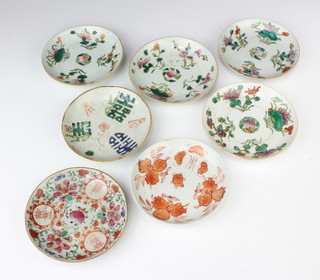 Seven antique style Chinese shallow dishes decorated with motifs 14cm 
