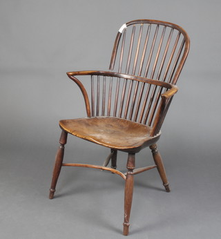 An 18th/19th Century yew and elm Windsor chair with solid seat and crinoline stretcher, raised on turned supports 
