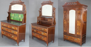 An Edwardian Art Nouveau 3 piece walnut bedroom suite comprising wardrobe with pierced heart shaped cornice enclosed by an arched panelled door flanked by a pair of carved panels the base fitted a drawer 216cm h x 129cm w x 53cm d, a dressing table with arched plate mirror, fitted 2 glove drawers, 2 short and 2 long drawers with brass plate drop handles 187cm h x 117cm w x 51cm d and a wash stand with arched plate mirror above a tiled splash back with black veined marble top and 3 drawers 173cm h x 117cm w x 48cm d 