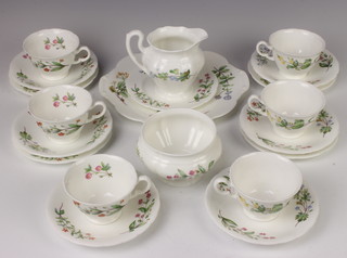 A Minton part tea set with multi floral decoration comprising 6 tea cups, 6 saucers, 5 side plates, cream jug, sugar bowl and sandwich plate  