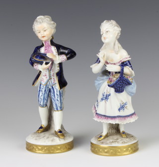 A pair of German porcelain figures of a young girl and boy, raised on circular bases 16cm 