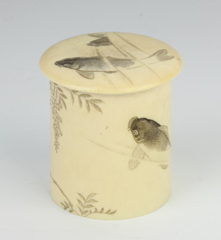 A Japanese Meiji period carved ivory cylindrical box and cover decorated with carp beneath wisteria, 6cm
